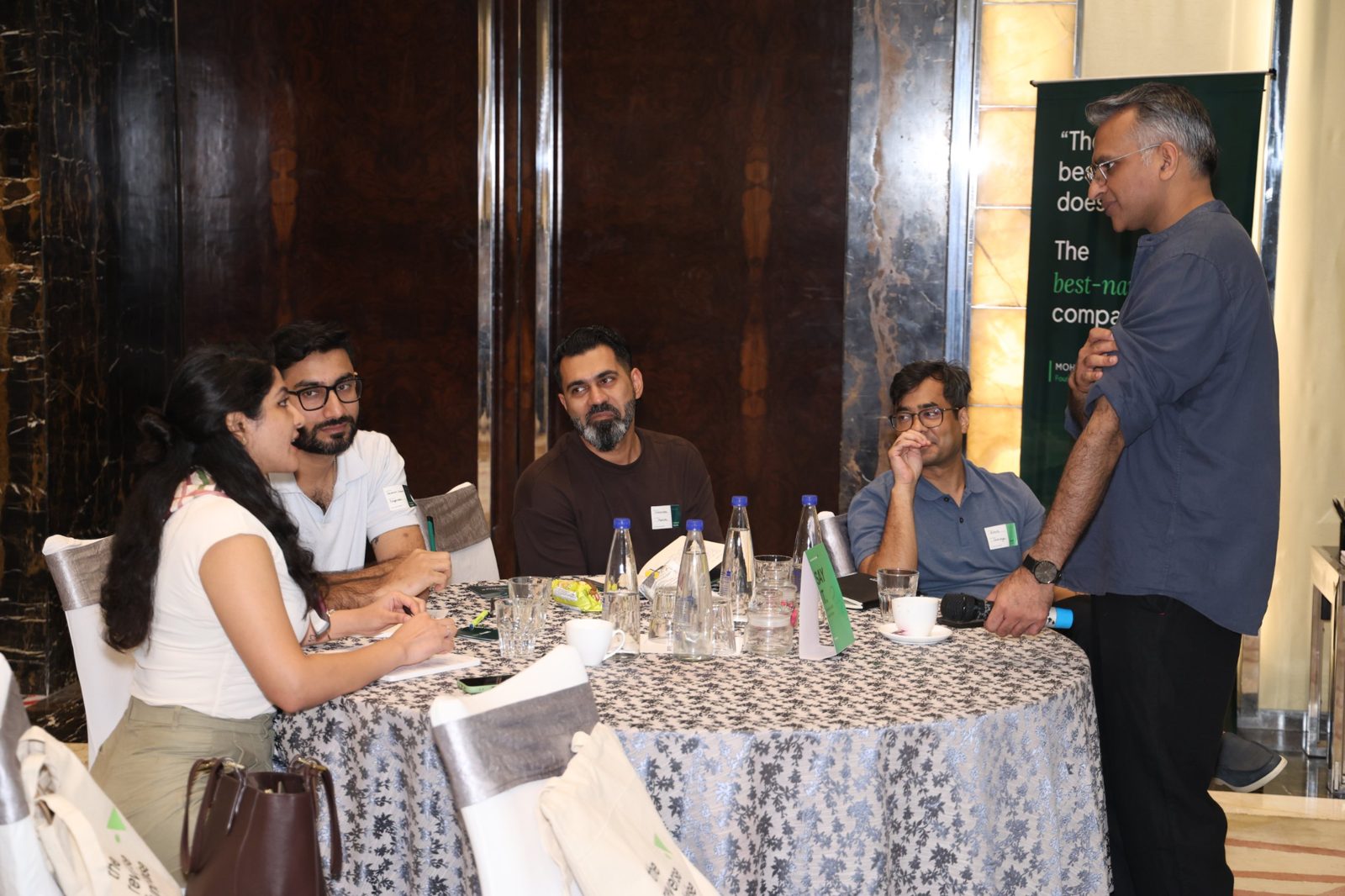Mohit with founders at a workshop table